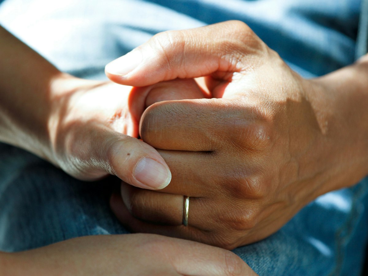 Two people holding hands